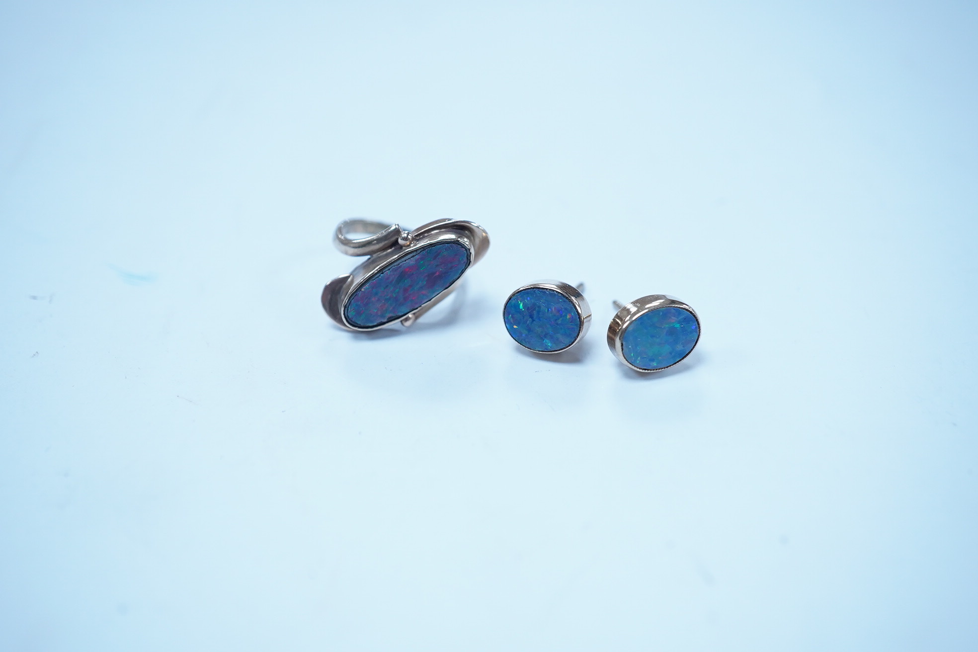 A 9ct and opal doublet ring and a pair of similar earrings, gross weight 4.8 grams. Condition - poor